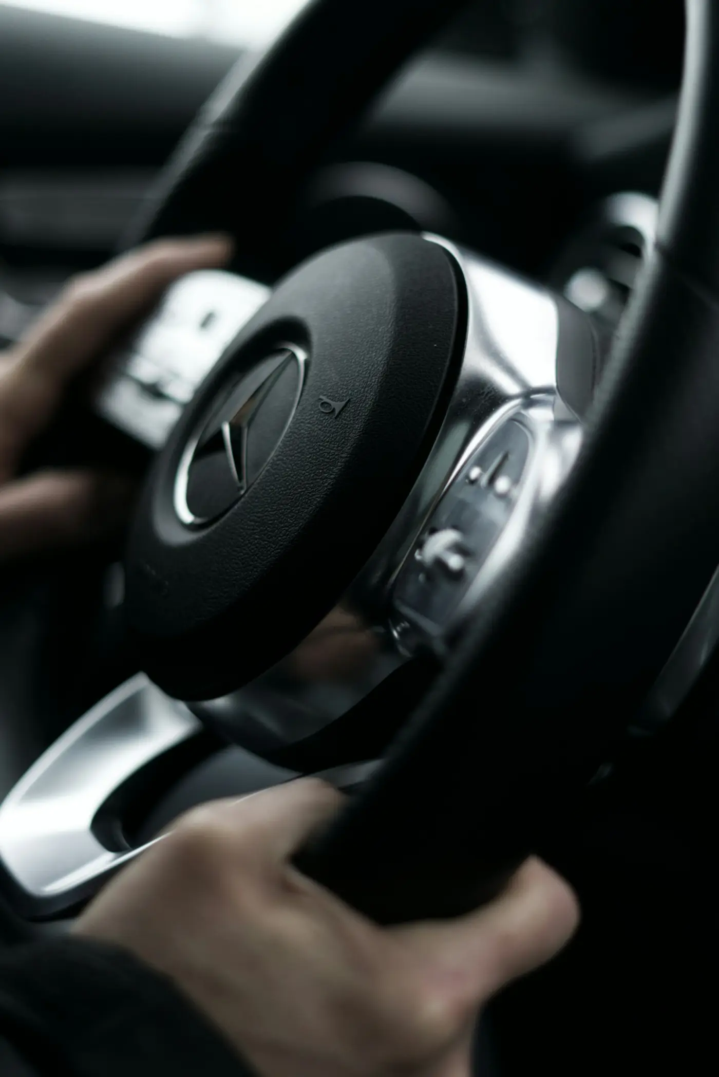Swiss premium chauffeur at the steering wheel of a luxury European executive vehicle — discreet professional driving